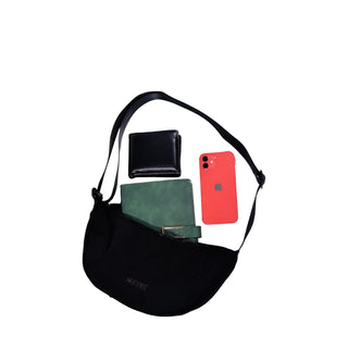 Black crossbody bag with wallet, phone, and green case on a white background with Polo Venzi branding.